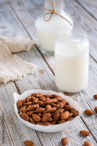 almonds and milk on the wooden table 
