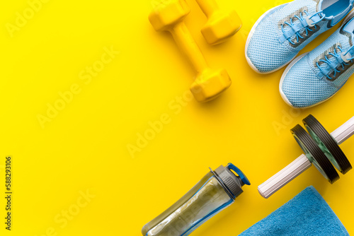 Gym and fitness equipment with sneakers and dumbbells