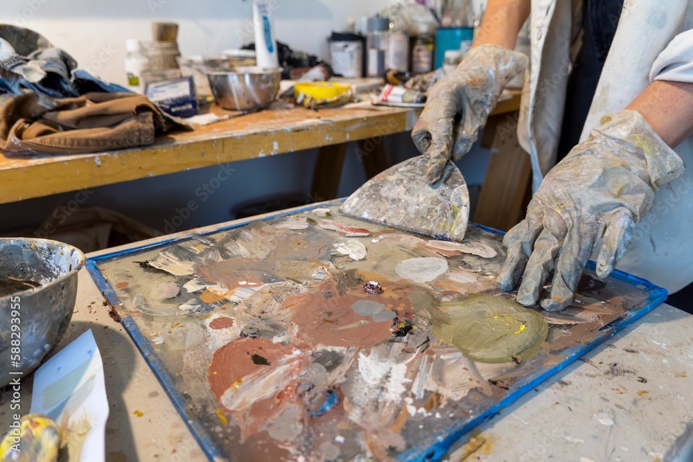 Girl is working with the paint in the studio. Girl is working with the paint in the studio.
