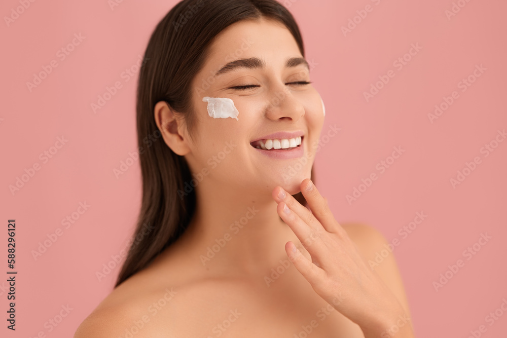 Happy young female with cream on cheek Happy young female with cream on cheek