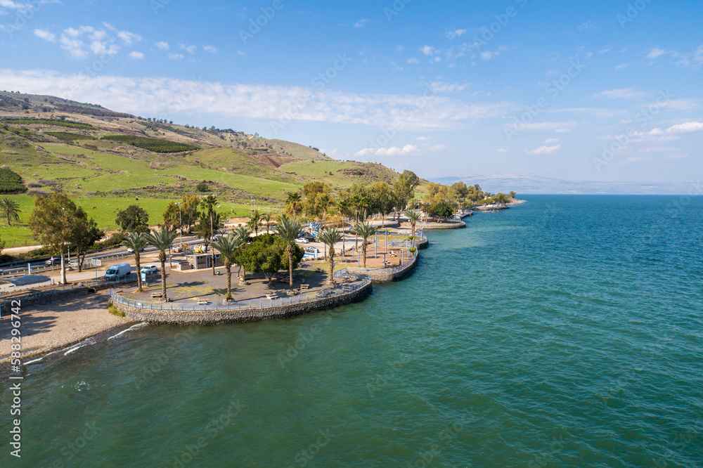 Aerial view of vehicles in a parking lot along the Jordan river