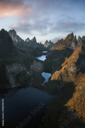 Aerial view of four lakes in one line enclosed by high mountains at sunset, Sorvagen, Lofoten, Norway.