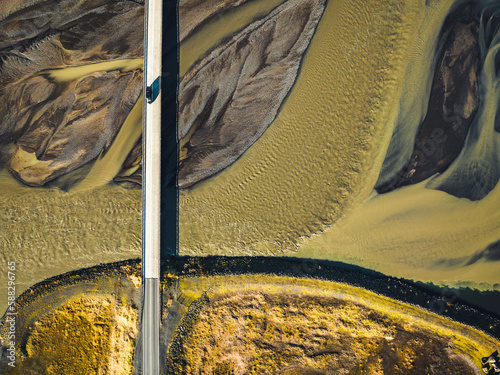 Aerial view of road crossing a glacial river on the southern region of Iceland. photo