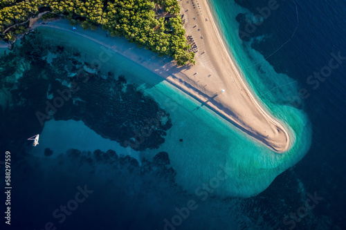 Aerial view of tourists and sailing boat on the shore of the beach in Bol, Croatia. photo