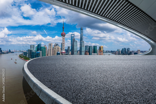 Asphalt road and bridge with city skyline in Shanghai, China. Road platform and modern architectural background.