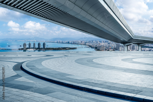 Empty square floor and pedestrian bridge with skyline in Sanya, Hainan, China.