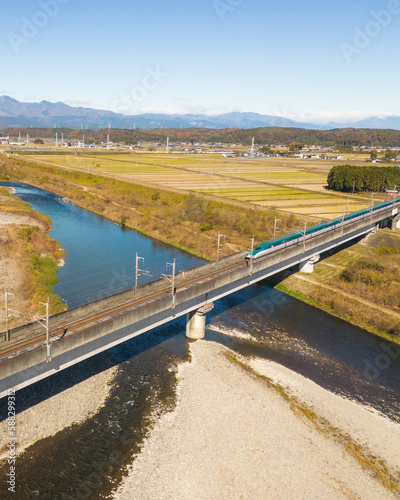 Aerial view of the Tohoku Shinkansen bullet train on a bridge, Tochigi, Japan.