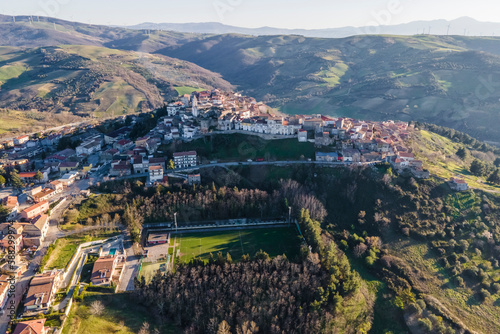Aerial view of Ripacandida, a small town on the hilltop with a football field in foreground, Potenza, Basilicata, Italy. photo