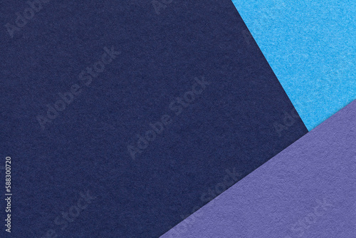 Texture of craft navy blue color paper background with turquoise and violet border. Vintage abstract cardboard.