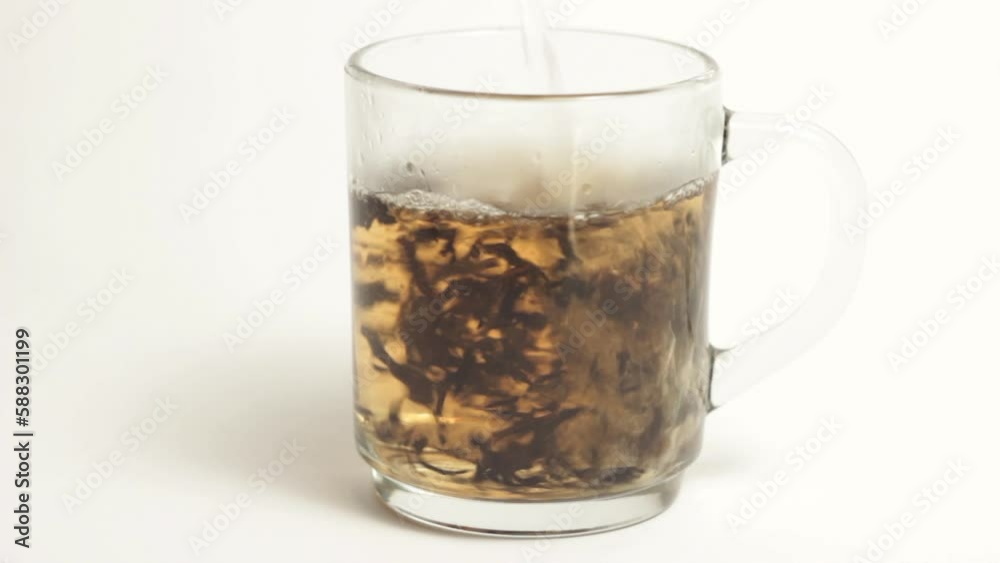 A video of boiled water being poured on tea leaves A video of boiled water being poured on tea leaves