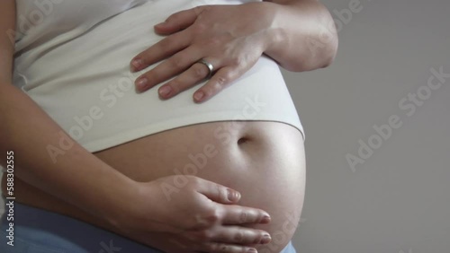 Pregnant woman rubbing her belly