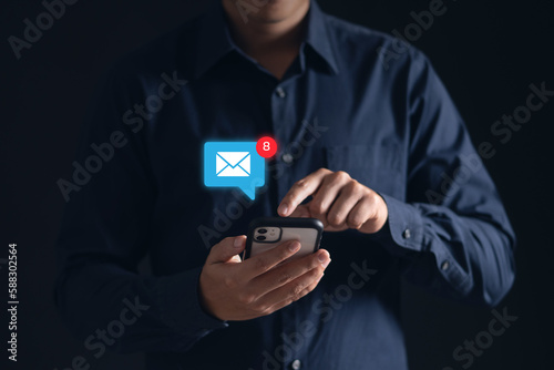 Stay connected with e-mail notifications! A man checks his inbox on his phone, keeping up with work and life on-the-go. Modern technology at its finest.