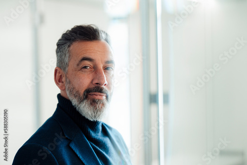 Businessman with gray beard in office