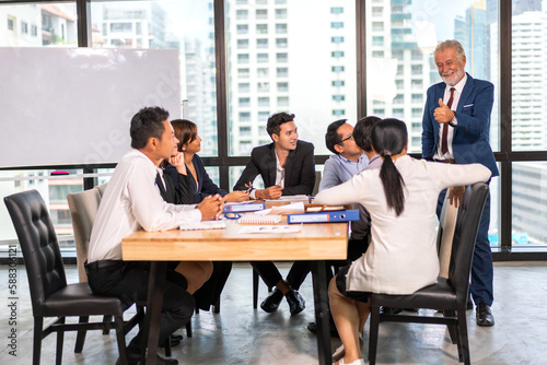 Group of creative asian business meeting and discussing strategy startup project analysis finance process.Success asian business people work plan and brainstorm marketing idea in office.Teamwork