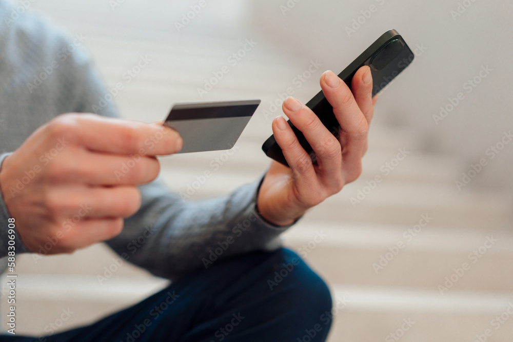 Hands of businessman holding credit card and smart phone Hands of businessman holding credit card and smart phone