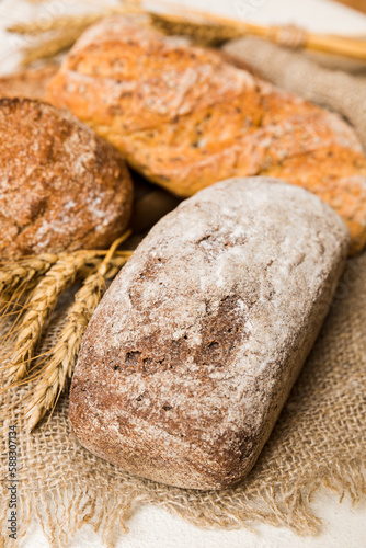 Homemade natural breads. Different kinds of fresh bread as background, perspective view with copy space