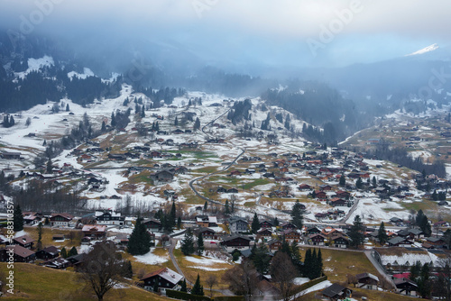 Aerial view of snow covered beautiful landscape at Swiss Alps. Winter holiday travel concept in Grindelwald village.