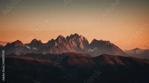 A serene sunset over a mountain range with warm  golden tones illuminating the peaks