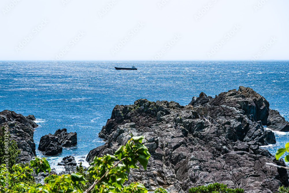 The sea and a tanker seen from the rocks