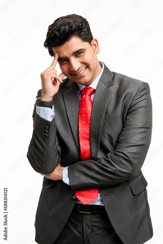 Young indian businessman in classic suit giving expression on white background. Young indian businessman in classic suit giving expression on white background.