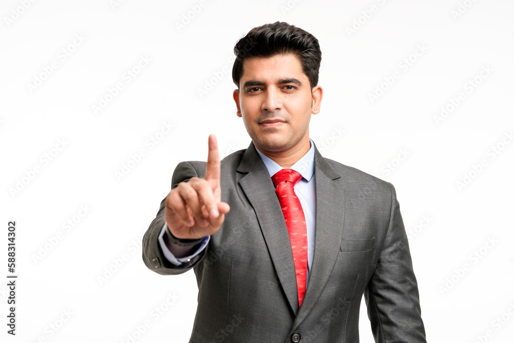 Young indian businessman pointing in front off with finger. Young indian businessman pointing in front off with finger.