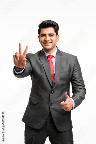 Young indian businessman showing thumps up