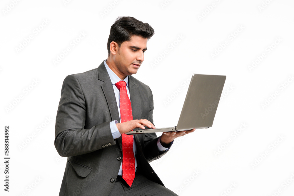 Young indian Businessman using laptop on white background. Young indian Businessman using laptop on white background.