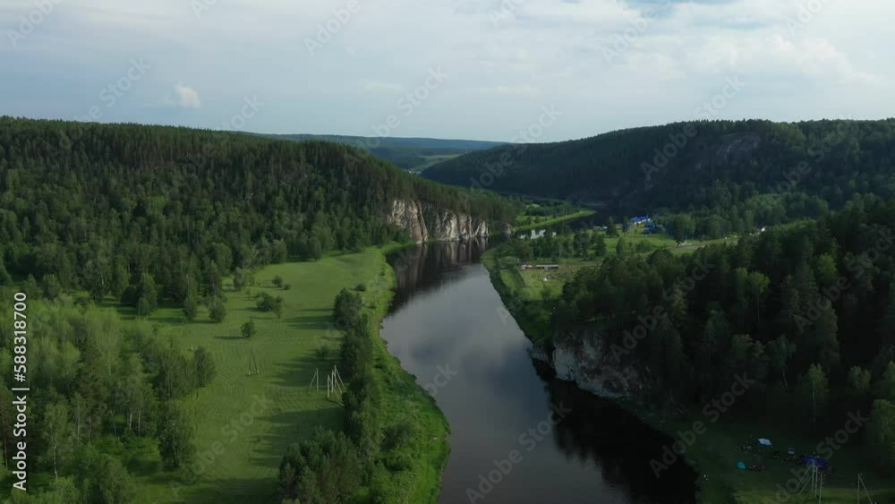Bird eye view of river in summer. Famous river Agidel in Bashkortostan. River flowing among green forest. Flying towards the rock Bird eye view of river in summer. Famous river Agidel in Bashkortostan. River flowing among green forest. Flying towards the rock