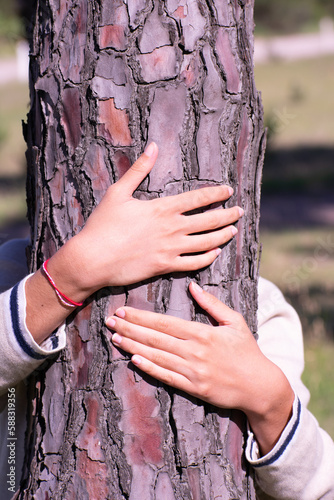 Adolescent Embracing Nature: Hugging a Tree © Pablo Echazarreta