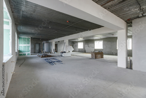 Spacious empty rooms in the attic floor after filling out the work on the wall and ceiling