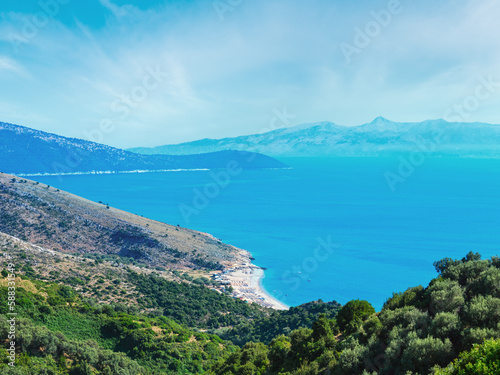 Adriatic sea summer coast with beach and Corfu island in mist  Lukove komuna  Albania. View from mountain pass.