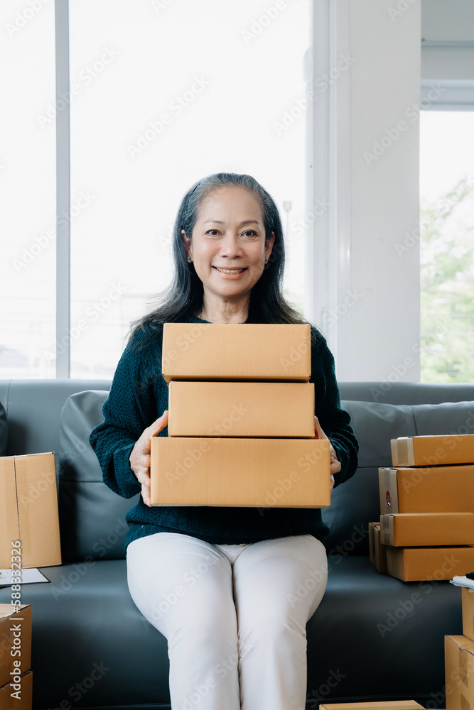 adult woman holding parcels and looking to camera, standing among several boxes in modern office. adult woman holding parcels and looking to camera, standing among several boxes in modern office.
