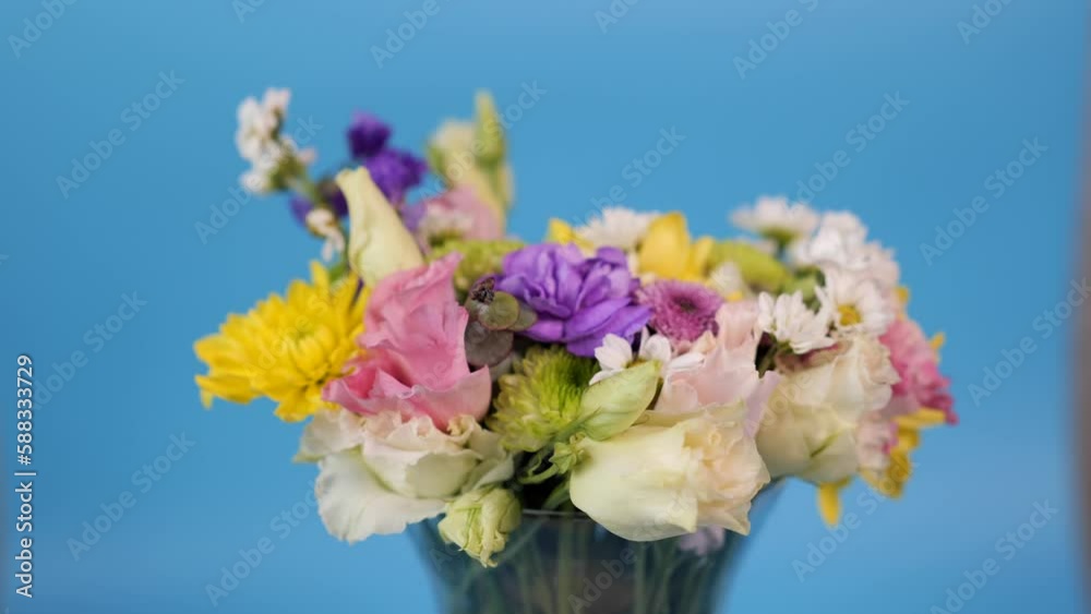 Rotation of summer bouquet on blue background Rotation of summer bouquet on blue background