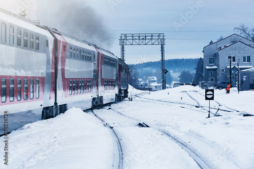 Passenger train departs at winter morning.
