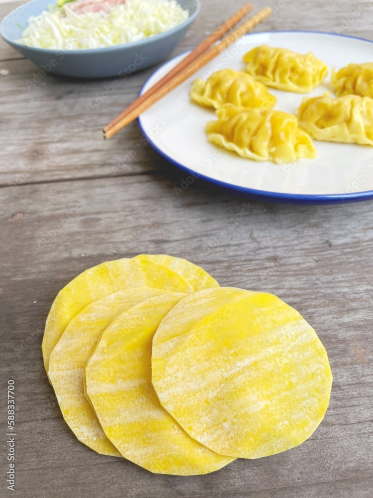 Dumpling dough on wood background
