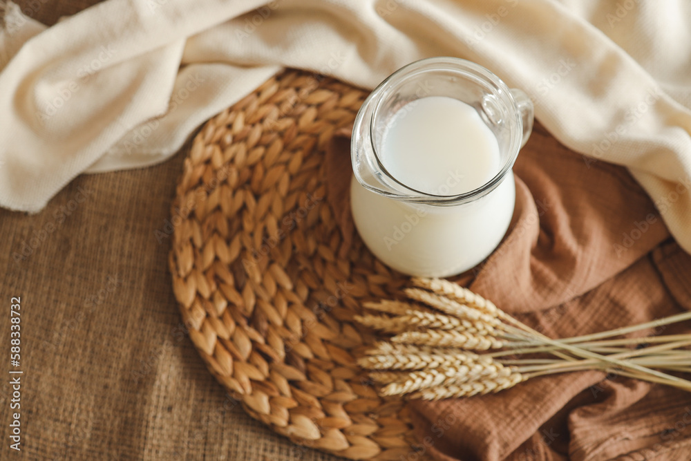 Glass of milk and ears of wheat close up Glass of milk and ears of wheat close up