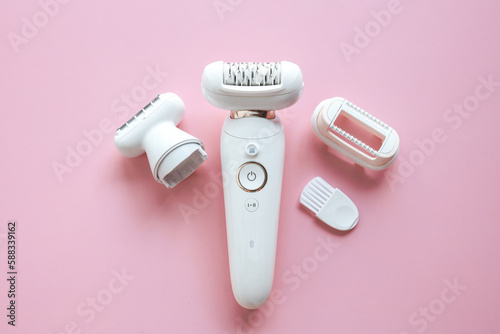 Quadro su tela Modern epilator on pink background, top view