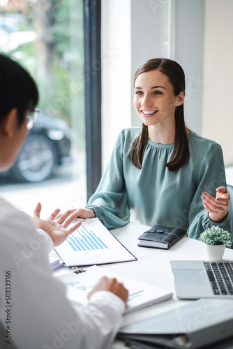 Vertical image of young confident business people analyze a document with partner, besiness meeting consult. Business concept