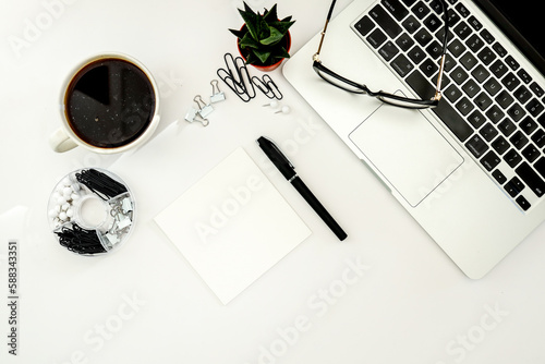 Fotografie White office desk table with blank notebook, computer keyboard and other office supplies