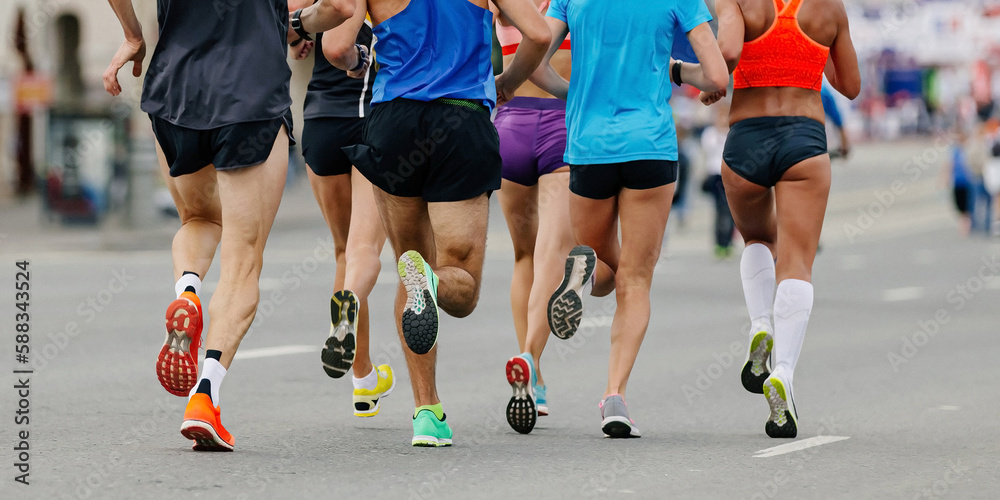 back legs group runners run marathon, female and male athletes jogging city race, sole running shoes back legs group runners run marathon, female and male athletes jogging city race, sole running shoes