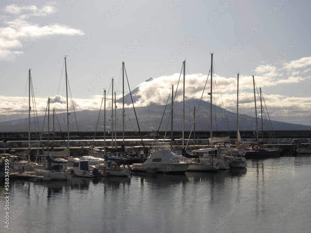 Azores Faial Harbor with  Small Boats and View on Pico Island Volcano in Background