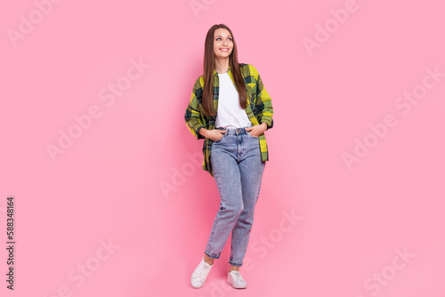 Full body photo of dreamy young woman wear stylish casual outfit bershka new collection look empty space advert isolated on pink color background photo