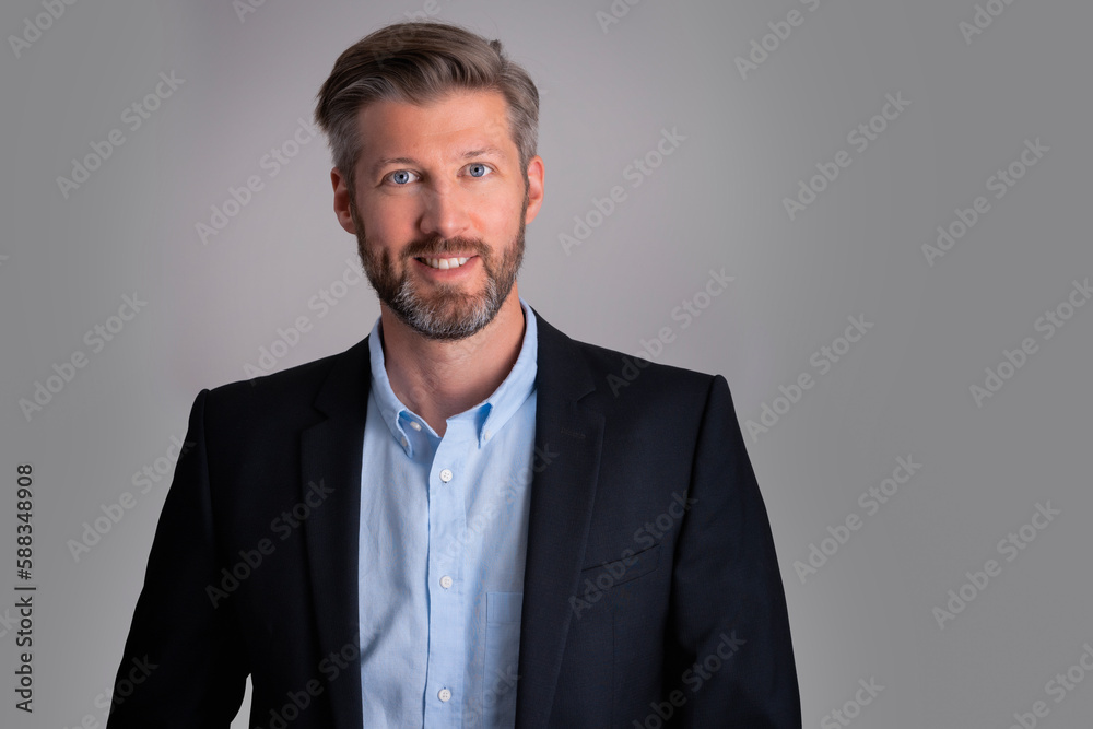 Portrait of confident businessman wearing shirt and suit while standing at isolated grey background Portrait of confident businessman wearing shirt and suit while standing at isolated grey background