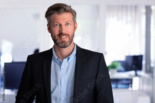 Portrait of confident businessman wearing shirt and suit while standing at the office