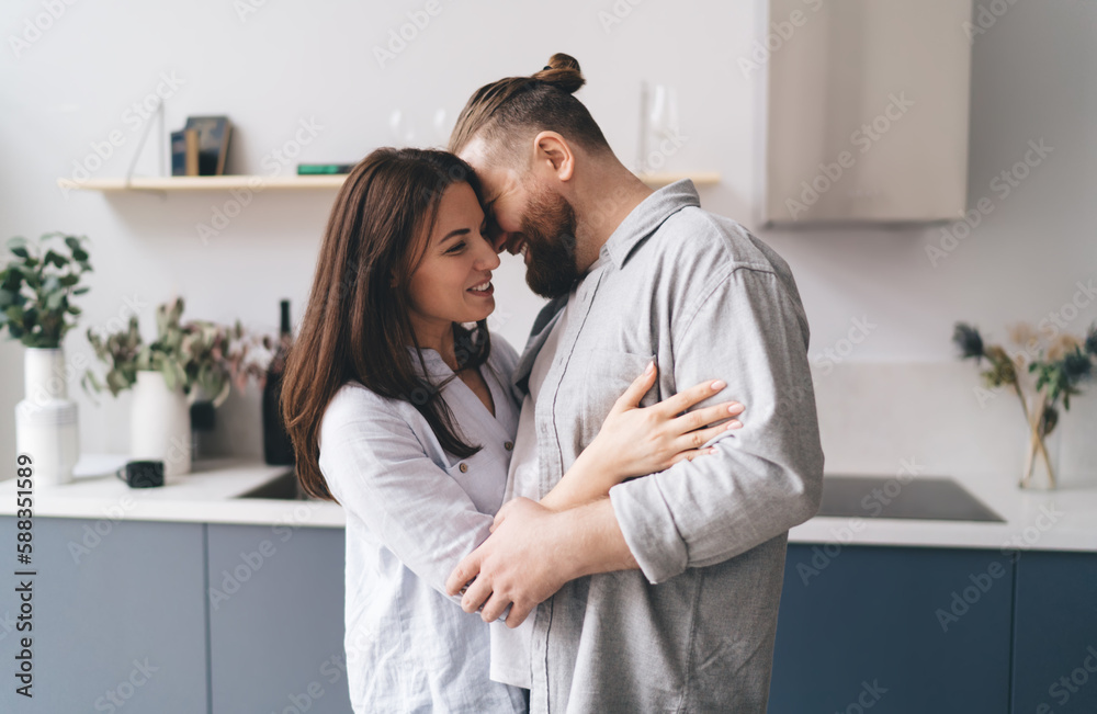 Happy couple hugging in kitchen Happy couple hugging in kitchen