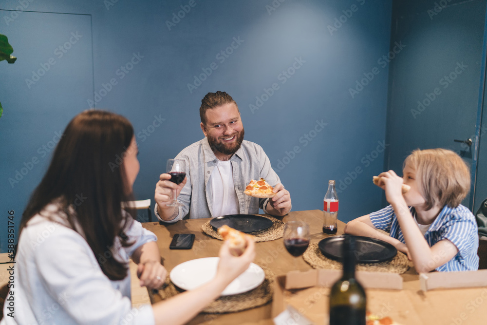 Smiling man having dinner with family on weekend
