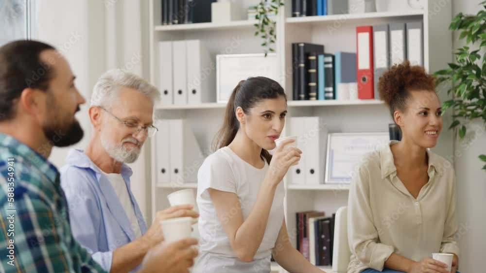 Multiethnic workers drinking coffee and talking during break, sitting in circle Multiethnic workers drinking coffee and talking during break, sitting in circle