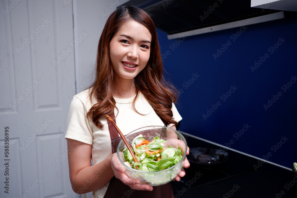 Smiling woman holding a plate of vegetable salad healthy food concept. Smiling woman holding a plate of vegetable salad healthy food concept.