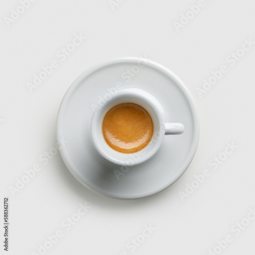 cup of coffee - top view on white background – Original Creamy Arabica Coffee in Traditional White Marble Cup, with Shadow, Focus on Cream – Detailed Close-Up Macro, 