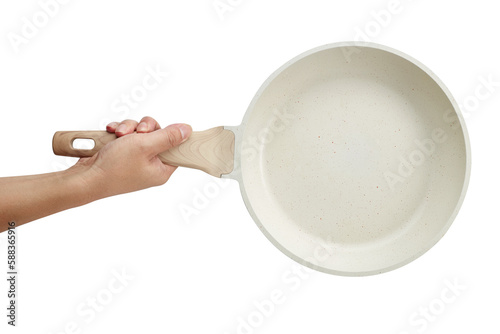 Hand holding a ceramic frying pan isolated on white background. Studio shot photo